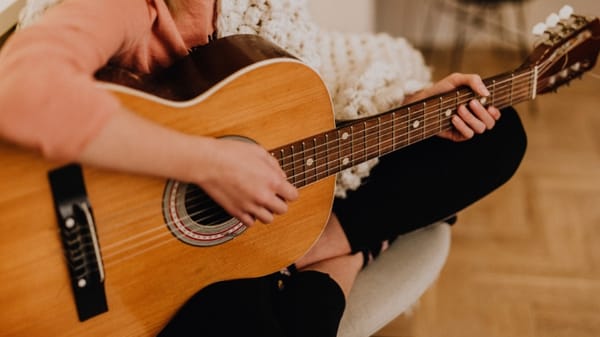 image: person playing guitar; article: How To Use The Pentatonic Scale In Real Life